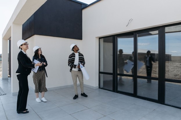 A group of people in white hardhats conducting an inspection a commercial property